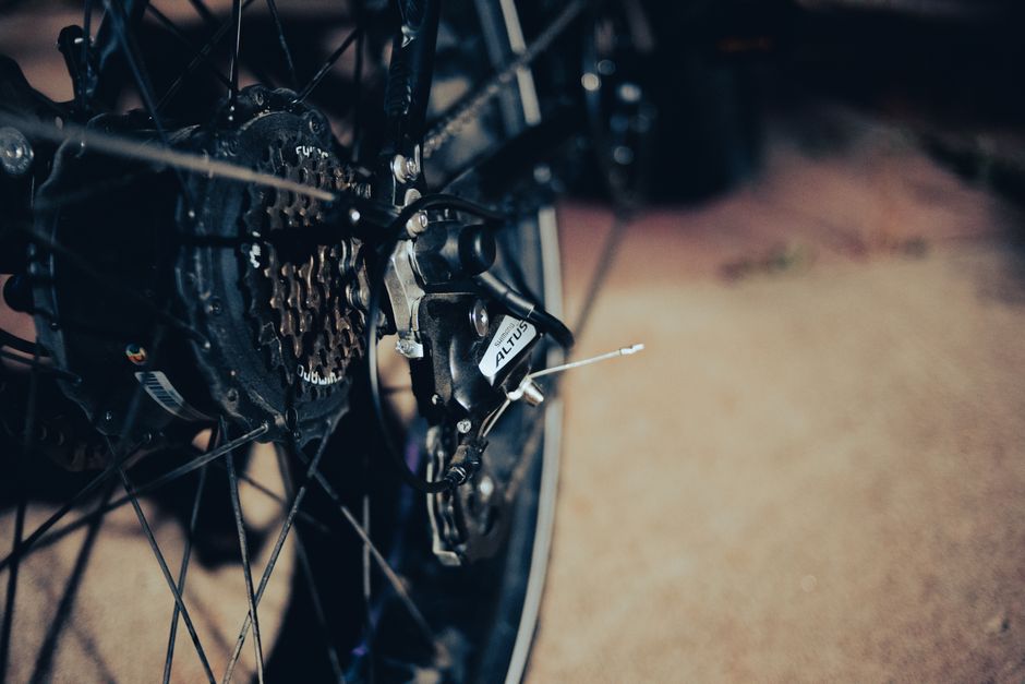 Detailed view of a bicycle rear derailleur and gears, emphasizing mechanical design.